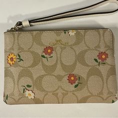 Nwt Coach Light Khaki/ Multi Corner Zip Wristlet With Nostalgic Ditsy Print Signature Coated Canvas And Smooth Leather Two Credit Card Slots Zip-Top Closure Fabric Lining Wrist Strap Attached 6.25”L X 4”H X .5”W A45 Spring Zipper Pouch Wristlet Clutch, Adjustable Wristlet For Spring, Coach Spring Pouch Wallet, Coach Pouch Wallet For Spring, Spring Coach Wristlet For Everyday Use, Coach Spring Wristlet For Everyday, Spring Pouch Wristlet With Zipper Closure, White Wristlet For Daily Use In Spring, Spring Wristlet With Zipper Closure In Pouch Shape