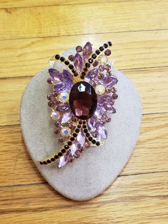 "1950s, 4\" long and 2\" wide, amethyst glass and pink rhinestone ornate brooch ,with gold tone molded back. Condition excellent Price $ 85" Purple Brooch Jewelry For Evening, Purple Amethyst Brooches For Wedding, Purple Rhinestone Party Brooches, Elegant Purple Rhinestone Brooches, Gemstone Brooch, Vintage Jewellery Rings, Feb 8, Glass Buttons, Rhinestone Jewelry