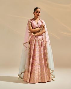 No matter how many offbeat hues we spot on brides, the shades of pink will always rule the wedding charts! There's a surreal charm in scrolling through pictures of beautiful brides clad in breathtaking pink bridal lehengas. Whether it's an intricately embroidered one or a contemporary shimmery design, the brides are swearing by a plethora of styles, all centered around a pink color palette! Introducing the carnation lehenga in charming pink. Crafted from exquisite banarasi silk, complemented by a v-neckline blouse. The dual-shade organza dupatta adds a touch of elegance. Carnation embodies tradition and modernity, offering a graceful ensemble for your cherished occasions. Panelled Lehenga, Banarasi Lehenga, Bridal Lehenga Designs, Padded Blouse, Indian Wedding Wear