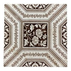 an intricately designed ceiling tile with flowers and leaves on the center, in brown and white