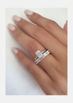 a woman's hand with a diamond ring on it