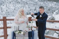 This delightful moment captures a bride in a stunning long sleeve wedding dress with lace detailing, sharing a celebratory sip with her groom in a dreamy winter setting. Their rustic deck ceremony is adorned with a velvet blue runner and a floral-clad wedding cake. The serene snow-covered scenery completes the romantic charm. 🌲💍 Check out these #WeddingIdeas for your special day! #LongSleeveWeddingDress #WeddingCake #WeddingHairstyles #TimelessWeddingDress #WildflowerWeddingTheme Rustic Deck, Wedding Dress With Lace, Long Sleeve Wedding Dress, Sleeve Wedding Dress