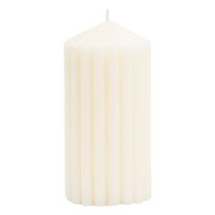 a white pillar candle on a white background