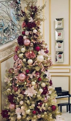 a christmas tree decorated with pink and gold ornaments