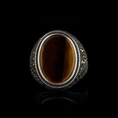 Tiger's Eye & Marcasite Silver Ring. Handmade in 925 sterling silver with tiger's eye stone. On the ring oval tiger's eye stone settled. At sides marcasite ornaments settled. Small and elegant. Dimensions of stone is 18 mm x 13 mm. Average weight of Tiger's Eye & Marcasite Silver Ring is 10 gr. (depends your ring size). Back side of the stone open to touch your skin. Stone Type: Tiger's Eye Stone Color: Brown Stone Dimensions: 18 mm x 13 mm Stone Shape: Oval, Flat Average Weight: 10 gr. Tigers Eye Gem, Eye Stone, Tiger Eye Stone, Signet Ring, Handmade Silver, Stone Color, Class Ring, Ring, Gemstone Rings