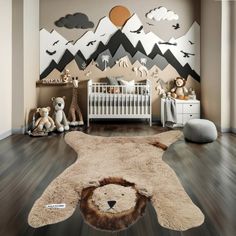 a baby's room with an animal rug on the floor and mountains in the background