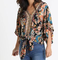 Black, floral, boho top with a tie waist Bohemian V-neck Blouse For Spring, Spring Bohemian V-neck Blouse, Casual Tie Neck Top For Vacation, Festival Floral Print V-neck Top, Bohemian V-neck Rayon Blouse, Floral Print Rayon V-neck Top, Festival V-neck Floral Print Top, V-neck Floral Print Top For Festival, Casual V-neck Blouse With Boho Collar