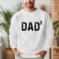 Celebrate Fatherhood with our Personalized Dad Sweatshirt featuring your kids' number! This custom dad sweat is the perfect Father's Day gift, great for pregnancy reveals, and a thoughtful addition to any dad's wardrobe. Show dad he's number one with this unique and meaningful gift.  Personalized Dad Sweatshirt, Fathers Day Gifts, Pregnancy Reveal 👉HOW TO ORDER👈 1️⃣  Choose your T-shirt color 2️⃣  Choose your T-Shirt size 3️⃣  Choose your design & text color 4️⃣ Need more Items? Add the curren White Long Sleeve T-shirt For Father's Day, Customizable Long Sleeve Sweatshirt For Father's Day, Family Matching Crew Neck Sweatshirt For Father's Day, Father's Day White Graphic Print Sweatshirt, White Graphic Print Sweatshirt For Father's Day, Father's Day Casual Sweatshirt With Name Print, Personalized White Sweatshirt For Family Matching, Father's Day Relaxed Fit Letter Print Sweatshirt, Father's Day Letter Print Relaxed Fit Sweatshirt