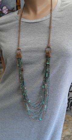 "Turquoise multi strand necklace, Long beaded gemstone necklace, Turquoise and old gold color, Gift for her, Handmade.  Total length of this necklace is 42,52\"/108 cm. Toggle clasp, handmade beaded cord. It is recommended to avoid contact with water/lotion/perfume. Important: Colors may look little different depending on your monitor settings. This necklace comes gift wrapped so it will be ready for gift. READY TO SHIP. Please notice: Combined postage is always available on multiple orders. Order more than one item, and pay only one postage." Cheap Turquoise Long Necklace, Luxury Single Strand Long Beaded Necklace, Unique Multi-strand Necklaces With Spacer Beads, Unique Multi-strand Necklace With Spacer Beads, Turquoise Multi-strand Jewelry For Jewelry Making, Multi-strand Beaded Turquoise Jewelry, Bohemian Multi-strand Spacer Beads Jewelry, Multi-strand Turquoise Gemstone Beads Necklace, Unique Turquoise Double Strand Necklace