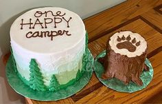 two cakes decorated with the words one happy camper and an animal's paw