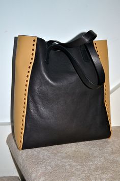 MARNI Italy New with tag, stunning soft Color-Blocked STUDDED SHOPPER calf leather tote bag ~ Black and Tan Smoothest and softest of the leathers make up this structured shopper bag. Color: COAL AND PEANUT (Dk gray and tan) Perfect weekend bag, such a beautifully constructed Italian gem. RETAIL PRICE $1600, from Saks Fifth Ave Goldtone metal studs Interior: Lined only in center panel, signature MARNI coal canvas. Check measurements: 13.5"H x 12.5"L x 5.75"D; lightweight. Made in Italy. AUTHENTIC Italy Interior, Black Leather Tote Bag, Weekend Bag, Handbag Black, Shopper Bag, Black Handbags, Weekender Bag, Leather Tote Bag, Black Tan