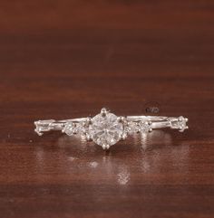 a diamond ring sitting on top of a wooden table