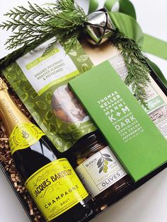 an open gift box filled with wine, beer and other items for someone's special occasion