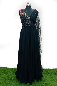 A mix of royal and modern, this long dress in Black colour handcrafted on georgette with multicolour crystal and stripes has an entirely different look because of the jacket. Style this for the classic indo western look.Fabric- georgette with net, work- metal stripes with multicolor crystalOccasion: Wedding ,Cocktail, Family & Pooja,Reception ,EngagementNo. Of Components: 1 Style: Gown Fabric: Georgette Work: Sequin, Cut dana Colour: Black Chest: 42 Note:- Originally Stitched in 42 but can alter Party Lehenga Embellished Maxi Length, Embellished Maxi Length Lehenga For Party, Hand Embellished Semi-stitched Party Dress, Maxi Length Embellished Lehenga For Party, Hand Embellished Georgette Saree Dress, Designer Party Wear Dresses With Cape Sleeves, Anarkali Party Set With Cape Sleeves, Designer Cape Sleeve Party Dresses, Designer Party Dress With Cape Sleeves