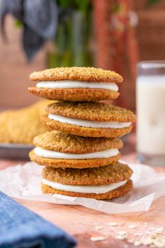 a stack of cookies sitting on top of a table next to a glass of milk