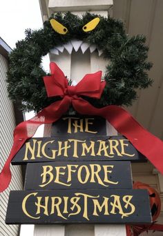 a sign that says the nightmare before christmas with a wreath on it's head