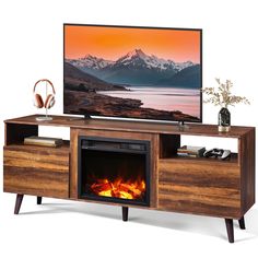 a flat screen tv sitting on top of a wooden entertainment center next to a fire place