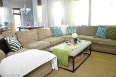 a living room filled with furniture and pillows on top of each other's couches