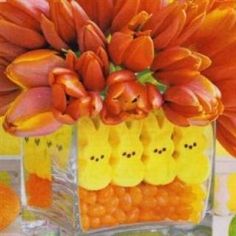 a vase filled with orange flowers and peep holes