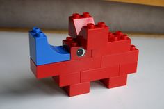 a red and blue elephant made out of legos