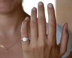 Sterling silver signet ring for women, minimalist custom engraved initials pinky ring.This simple and dainty signet ring is made of sterling silver. It will be especially beautiful as a pinky ring will look great on any finger you choose to wear it. The ring is not hollowed and has a shiny finish, also on the inside. This ring can be customized: It can be hand engraved to up to 3 letters. The engraving can be made with a font of your choosing - you can even write it in your own handwriting.Nothi Fine Jewelry Sterling Silver Signet Ring Gift, Silver Oval Initial Ring Tarnish Resistant, Minimalist Open Signet Ring With Engraving Option, Everyday White Gold Signet Ring, Minimalist White Gold Engraved Ring With Polished Finish, Adjustable Sterling Silver Engraved Ring, Tarnish Resistant, Minimalist Engraved White Gold Ring With Polished Finish, Adjustable Sterling Silver Engraved Ring Tarnish Resistant, Silver Signet Ring For Everyday