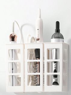 an assortment of hair and beauty products are arranged on a white shelf with dividers