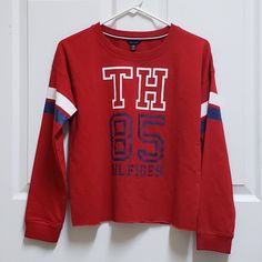 Tommy Hilfiger Boys' Xl Long Sleeve Red White Blue T Shirt Stripe On Arms 60% Cotton, 40% Polyester Excellent Condition New Without Tags Collegiate Long Sleeve Red T-shirt, Red Collegiate Long Sleeve T-shirt, Red Collegiate Cotton Top, Tommy Hilfiger Cotton College Tops, Casual Tommy Hilfiger Tops For College, Tommy Hilfiger Casual Tops For College, Red Long Sleeve Collegiate T-shirt, Tommy Hilfiger Winter Streetwear Tops, Red Winter Tops For College