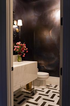 the bathroom is decorated in black and white