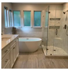 a large bathroom with a tub, sink and window in the shower stall is shown