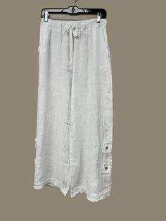 Indulge in luxury with these Button Detail Linen Pants. Made from premium Italian linen, these pants feature sophisticated button detailing, a flattering wide leg, and an elastic waist with drawstring for the perfect fit. With two front pockets and a distressed hem, these pants offer both style and comfort, making them a must-have for any elegant and cabin chic wardrobe. One Size (fits S-L) Earth Sheltered Homes, Cabin Chic, Earth Sheltered, Chic Wardrobe, Scarf Belt, Winter Tops, Fall Shopping, Hat Shop, Linen Pants