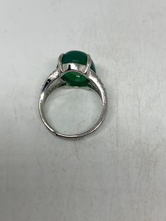 Vintage Lucky Green Nephrite Jade ring Large green nephrite jade Ornate silver finished White bronze Vintage ring, does not tarnish, NOT sterling Size 6-8 adjustable My jeweler can custom re size for a $10-$20 fee All rings are shipped free in the US in a nice gift box. Check out our over a THOUSAND great reviews Engraving is $4 per letter and is not always perfect depending on the piece. It can take a few days if the jeweler is busy. This is payable to Paypal Judithsltd@gmail.com Adjustable Silver Emerald Ring, Adjustable Oval Emerald Rings, Adjustable Jade Ring, Silver Jade Promise Ring, Silver Jade Rings For Promise, Adjustable Green Jewelry With Polished Finish, Adjustable Green Jade Rings, Adjustable Green Polished Jewelry, Adjustable Green Nickel-free Ring