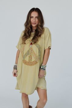 Calling all of our peace gals, we have the top for you; the Retro Peace Tunic Top is so boho cozy with a fun design you'll get so many compliments in! This will be the tunic top you always want to wear because it features: Comfortable, mineral - washed, Cotton jersey fabric Relaxed and loose tunic tee shirt dress silhouette Classic ribbed crew neckline and dropped shoulders with loose short sleeves So cute peace sign patch along the center with mixed floral prints Exposed seams with raw edges th Casual Tunic Top For Loungewear, Casual Boho Print Tunic Top, Bohemian Summer Loungewear Tops, Bohemian Crew Neck Top For Festivals, Casual Peace Sign Summer Top, Fall Vacation Cotton Tunic, Casual Boho Print Tops For Festivals, Oversized Cotton Bohemian Tunic, Oversized Hippie Tops For Fall