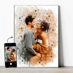 an image of two people kissing in front of a cell phone with the photo on it