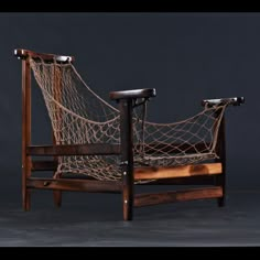 a chair made out of wood and rope with one arm resting on the other side