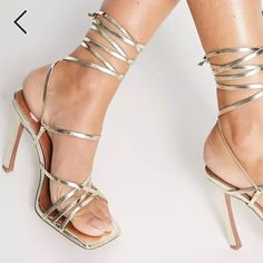 Brand: Asos Design Size: 8 Color: Gold Condition: Never Worn Details: - Strappy Design - Tie-Leg Style - Open Toe - High Point Heel - Care: Wipe Clean With A Damp Cloth Or Sponge - Metallic Faux-Leather Upper. Lining Sock: 100% Other Materials, Sole: 100% Other Materials, Upper: 100% Other Materials. Gold Lace-up Sandals With Heel Strap For Summer, Glamorous High Heel Lace-up Sandals For Summer, Gold Lace-up Sandals For Party, Gold Lace-up Party Sandals, Chic Strapped Sandals For Summer, Summer Party Lace-up Sandals With Strap, Gold Strappy Lace-up Sandals, Gold Fitted Strappy Sandals, Gold Lace-up Sandals For Summer With Open Heel