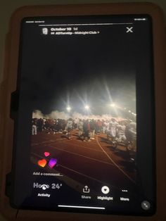 a cell phone with an image of a tennis match on it's display screen