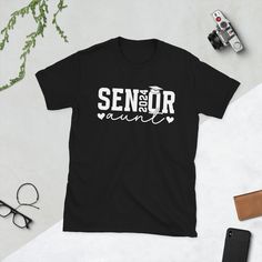 Cute senior aunt 2024 idea for the proud auntie of class of 2024 graduates. Great senior 2024 aunt idea for the auntie of class of 2024 graduates at class of 2024 graduation. * 100% ring-spun cotton * Sport Grey is 90% ring-spun cotton, 10% polyester * Dark Heather is 65% polyester, 35% cotton * 4.5 oz/yd² (153 g/m²) * Shoulder-to-shoulder taping * Quarter-turned to avoid crease down the center * Blank product sourced from Bangladesh, Nicaragua, Honduras, Dominican Republic, Haiti or Guatemala T 2025 Graduation, Grandmas Mothers Day Gifts, Senior Shirts, Scrapbook Gift, Color Guard, Class Of 2024, Dominican Republic, Shirt Price, Shoulder Taping