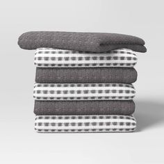 four towels stacked on top of each other in grey and white checkered pattern,