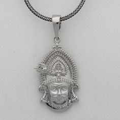 Khatu Shyam's teachings emphasize the importance of karma, devotion, and surrender. He is also known as Shyam, Barbarik, Khatushyam, Morvi Nandan, and Sheesh Ke Dani Metal-925 sterling silver. Item type-Pendant/ Locket Weight-7.040 grams. Height-4.5 centimetre. Width-1.9 centimetres. Stamped-925. Chain details:(if buyer wants to purchase) Chain width-1.5mm(if buy) Weight-12.500 to 18.500 grams(weight vary as per length) Chain Type-screw chain/ pendant chain. Spiritual White Gold Jewelry With Large Pendant, Spiritual Large Pendant Jewelry For Rituals, Spiritual Sterling Silver Necklaces For Rituals, Spiritual Hallmarked Pendant Jewelry, Silver Ceremonial Jewelry For Diwali, Silver Jewelry For Ceremonial Diwali Occasion, Silver Jewelry For Ceremonial Occasions During Diwali, Sterling Silver Amulet Necklace For Puja, Sterling Silver Amulet Necklaces For Puja