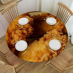 the table is set with white plates and silverware in front of an image of fried food