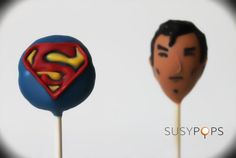 there are two superman lollipops on top of each other, one with a man's face