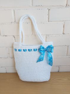 White Crochet Summer tote bag with ribbon. This stylish handbag is perfect for gift, using everyday, at the beach or for shopping. Bag is made of thick polyester rope. You may custom order this design in this or different color and size. White Bucket Shoulder Bag As A Gift, White Square Crochet Bag With Braided Handles, White Square Straw Bag With Handles, White Crochet Bag For Summer Gift, White Square Beach Bag For Shopping, White Straw Shoulder Bag, White Summer Bag As A Gift, White Straw Shoulder Bag Gift, White Rectangular Straw Bag For Gift