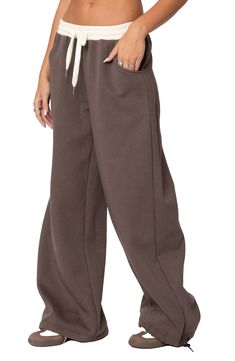 Cozy and cool, these sweatpants feature a relaxed, slouchy fit with wide legs, a contrasting low-rise waist and a soft cotton-blend fabrication that'll keep you ultracomfy. Elastic/drawstring waist Front scoop pockets 50% cotton, 50% polyester Machine wash, dry flat Imported Baggy Full-length Drawstring Sweatpants, Trendy Wide-leg Cotton Joggers, Trendy Baggy Sweatpants With Drawstring, Cotton Wide Leg Joggers, Sporty Cotton Wide Leg Pants With Loosely Fitted Hips, Sporty Cotton Wide Leg Pants With Loose Fit, Baggy Fall Full Length Sweatpants, Oversized Wide Leg Sweatpants For Fall, Relaxed Fit Wide Leg Sweatpants With Ribbed Cuffs