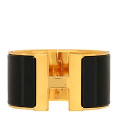 This is an authentic HERMES Enamel Extra Wide Clic Clac H Bracelet GM in Black. This chic bracelet has a wide band of plated gold with a hinge on one side and opens with a swivel Hermes "H" on the prominent side. Around the band is a strip of enameled black set into the gold. 1433580 Luxury Gold Bangle With Black Enamel, Designer Gold Bracelets With Black Enamel, Formal Yellow Gold Bangle With Black Enamel, Elegant Black Jewelry With Gold-tone Hardware, Luxury Cuff Bracelet With Box Clasp For Formal Occasions, Luxury Formal Cuff Bracelet With Box Clasp, Modern Gold Bracelets With Black Enamel, Luxury Black Jewelry With Gold-tone Hardware, Black Jewelry With Gold Clasp For Formal Occasions