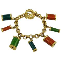 NINA RICCI vintage rare gold toned bracelet featuring multicolored enamel sewing thread spool charms. T-bar closure. Embossed NINA RICCI. Indicative measurements : length approx. 18.5 cm (7.28 inches). JEWELRY CONDITION CHART - New or never worn : item is in pristine condition with no noticeable imperfections - Excellent : item has been used and may have not more than two minor imperfections - Good : item has been used and may have more than two minor imperfections - Fair : item has been used an Nina Ricci Vintage, Spools Of Thread, Buy Earrings Online, Thread Bracelet, Retro Bracelet, Vintage Charm Bracelet, Gems Bracelet, Thread Bracelets, Buy Earrings