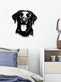 a black and white dog's face is shown on the wall above a bed