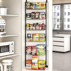 an organized pantry in a kitchen with white cabinets and stainless steel shelving unit holding various food items