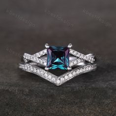 an engagement ring set with a blue diamond and white topaze diamonds on it