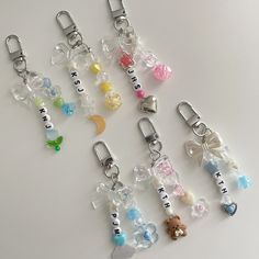 several charms are arranged in the shape of teddy bears and other items on a white surface