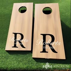 two personalized cornhole game boards with the letters r and person engraved on them